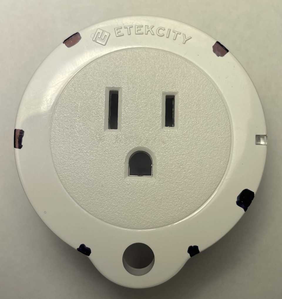 Etekcity Voltson ESW01-USA-R6P Shell Clips Front View A top-down front view of an Etekcity Voltson ESW01-USA-R6P Smart Outlet. The outlet, button, and LED indicator are facing the viewer. Black marks around the circumference of the plug indicate the locations of the six clips of the plastic shell. The markings are positioned clockwise at 40°, 120°, 155°, 205°, 270°, and 325°.
